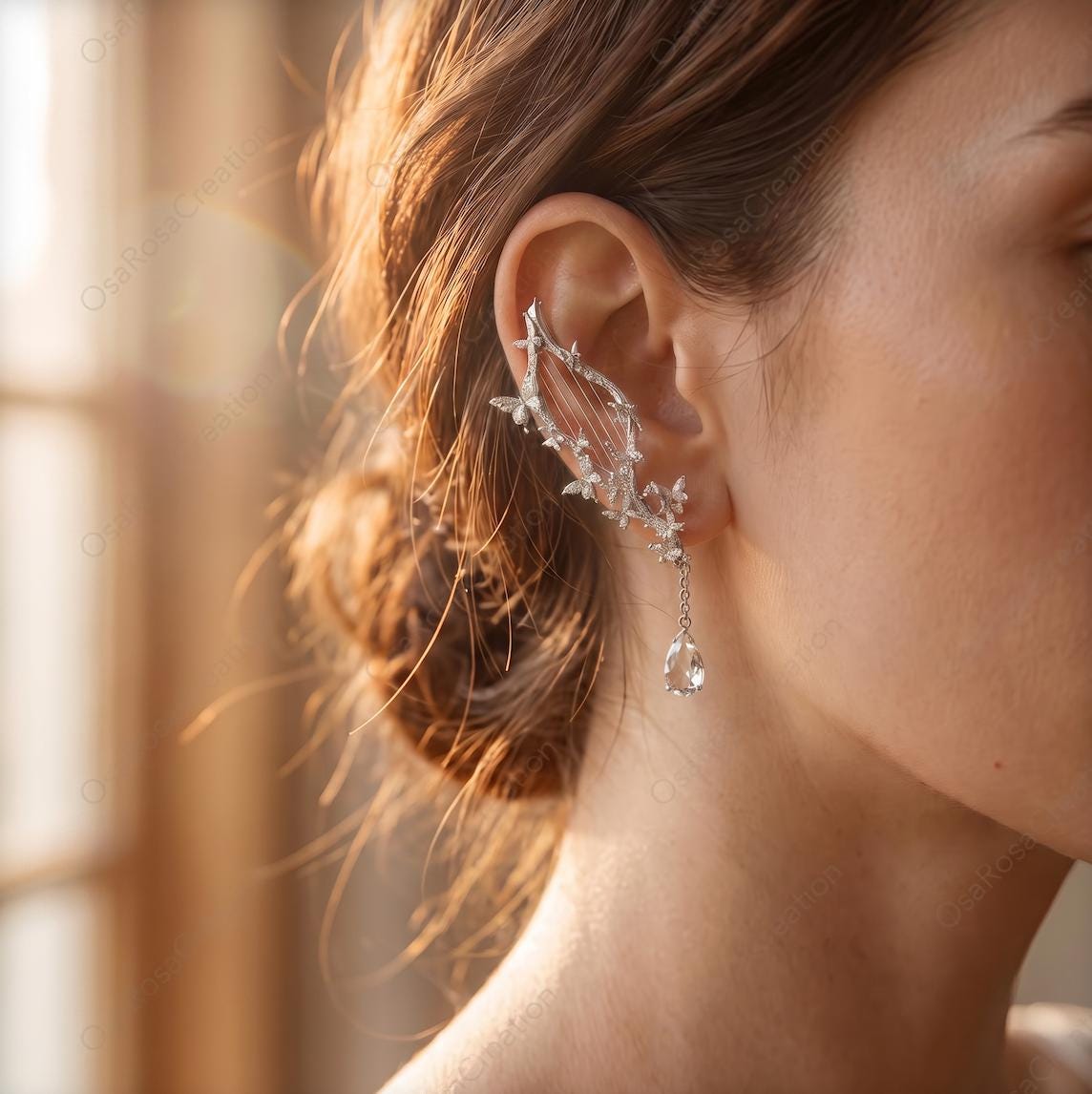 Elven Harp Ear Cuff worn on the ear, with a silver-toned harp frame and teardrop crystal
