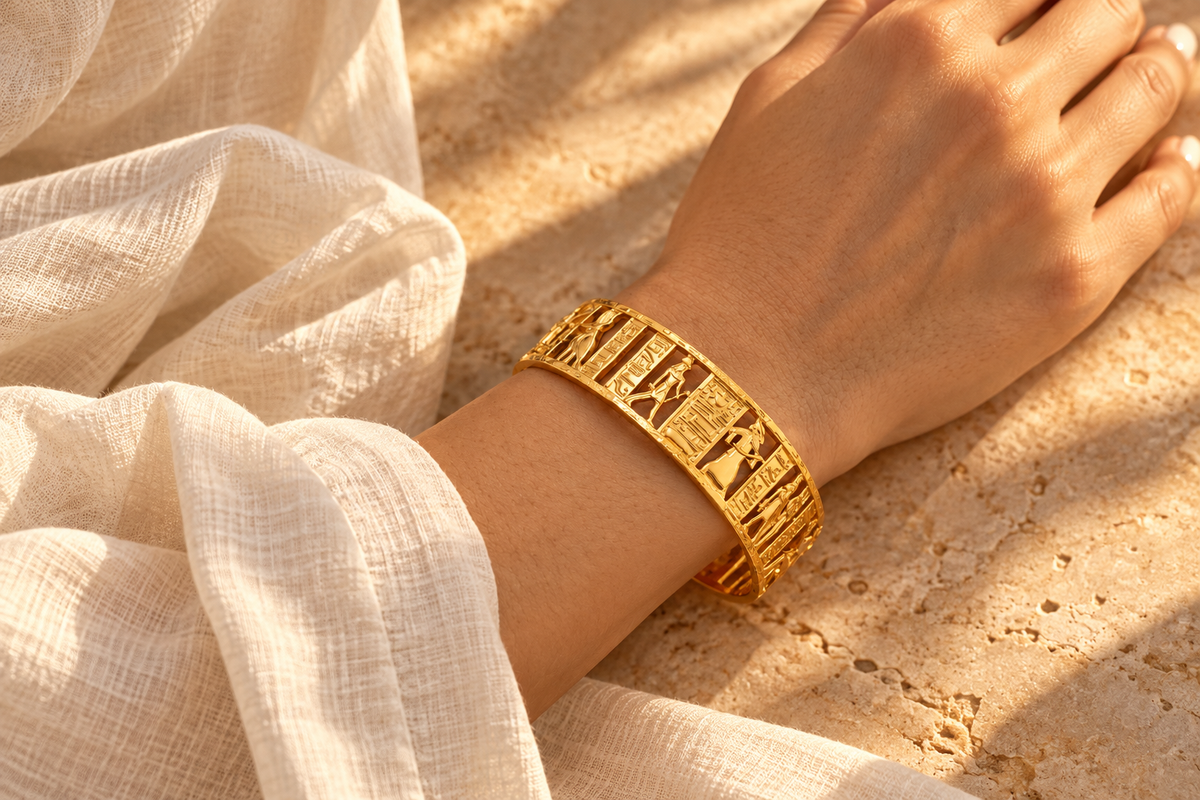 Egyptian openwork cuff on a relaxed wrist beside an ivory sleeve