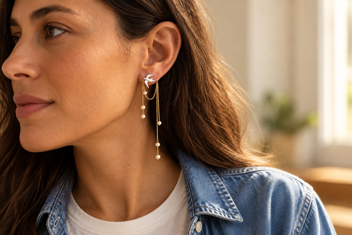 Bird and pearl-accent chain earrings styled with an ivory T-shirt and blue denim shirt