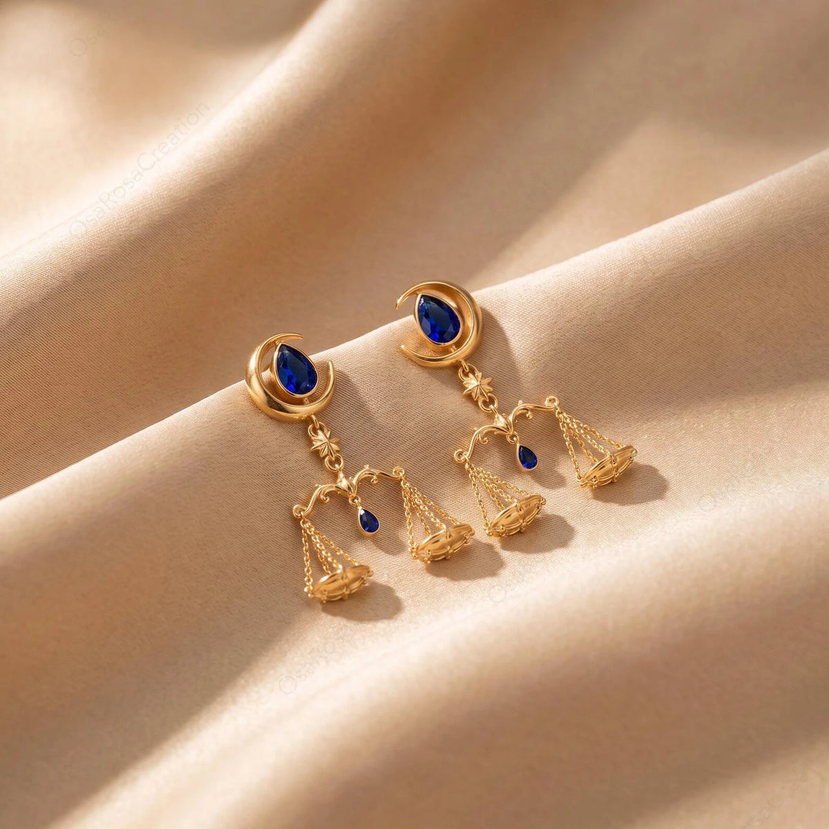 Celestial Balance Libra earrings pair with crescent moons, blue teardrop accents and suspended scales