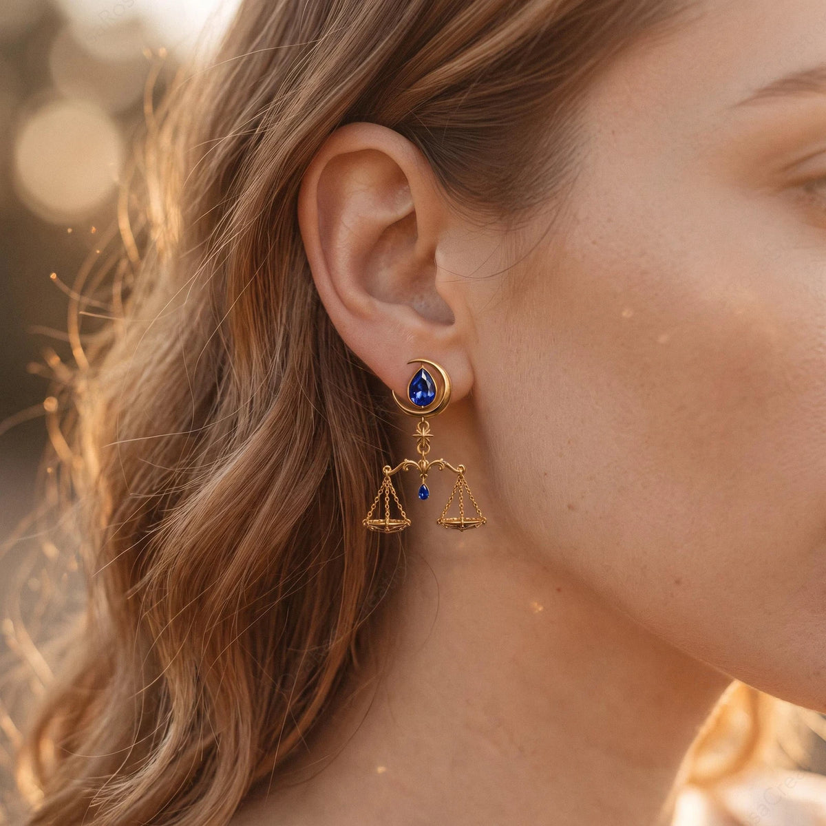 Celestial Balance Libra earrings shown worn beside the face