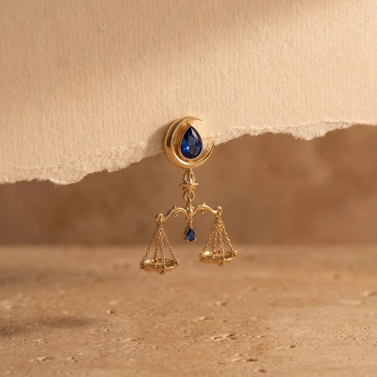 Close-up of crescent moon, star, blue accent and suspended scales
