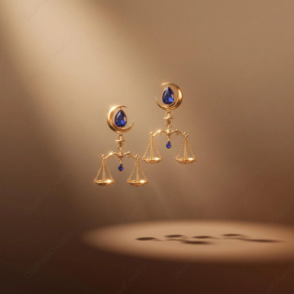 Celestial Balance Libra earrings pair displayed against a warm background